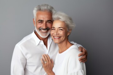 Beautiful gorgeous 50s mid age elderly senior model couple with grey hair laughing and smiling. Mature old man and woman close up portrait. Healthy face skin care beauty, skincare cosmetics, dental.