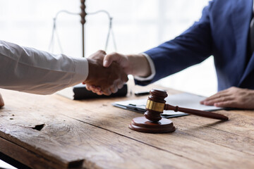 Businessman Shaking Hands In Front Of Mallet, justice and law concept. male lawyer working in office. Legal law, advice and justice concept.