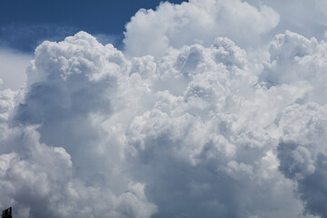 Naklejka na ściany i meble Close-up of a cumulus congestus cloud in the blue sky