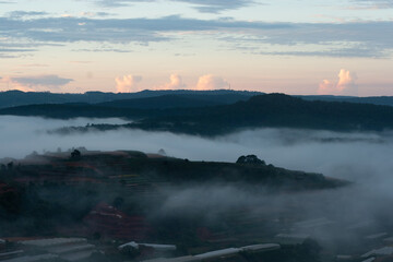Dawn on the outskirts of Da Lat, a morning with dew covering the hilltops, in the sky there are beautiful colorful fish scale clouds.