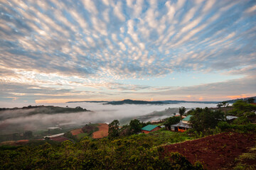 Dawn on the outskirts of Da Lat, a morning with dew covering the hilltops, in the sky there are beautiful colorful fish scale clouds.