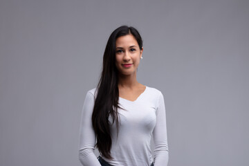 Fototapeta premium Attractive dark haired woman looking at camera with a smile