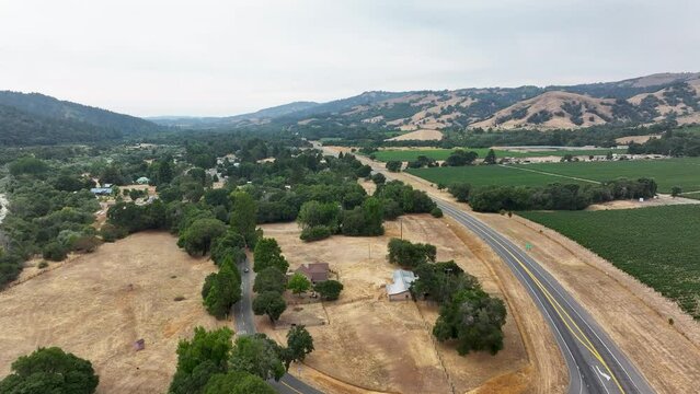 Aerial California Boonville city vineyard farms traffic 1. Mendocino county, California. Grape, wine farm regions along Navarro River. Mountains, hills, valley and farming. Redwood and pine forests.