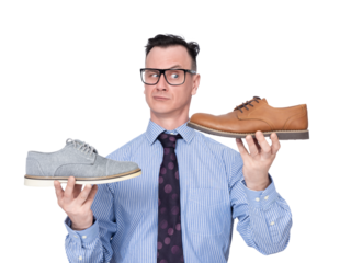 A man in glasses, shirt and tie holds two shoes in his hands, pointing at the camera, , isolated on a transparent background png. 