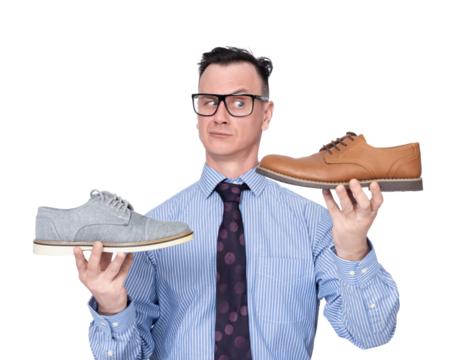 A man in glasses, shirt and tie holds two shoes in his hands, pointing at the camera, , isolated on a transparent background png. 
