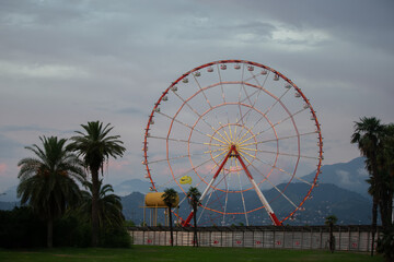 Retro ferris wheel carousel on the background of the evening sky.