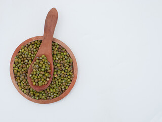 green bean seeds on a wooden plate