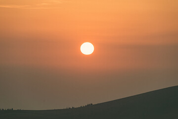 The sun sets on the mountain. Beautiful sunset in a mountainous area.