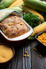Cornbread in ceramic baking dish on wooden kitchen table