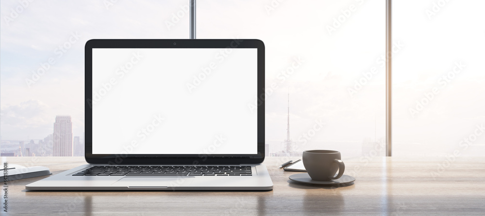 Aufkleber Wide image of laptop with empty white mock up monitor, coffee cup and notepad placed on wooden desktop. Window with bright city view in the background. 3D Rendering.