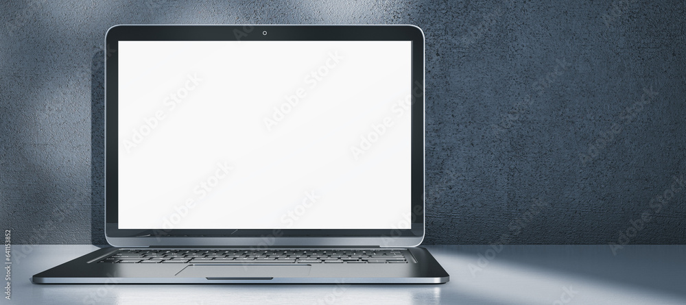 Aufkleber Wide image laptop computer with empty white mock up screen placed on desk. Concrete wall with shadows in the background. 3D Rendering.