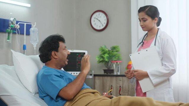 Indian patient angry on doctor due to negligence in medical treatment at admitted hospital ward - concept of Healthcare Upset, dispute and wrong treatment