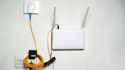 Wi-Fi router with two antennas on the wall. Technology concept.
