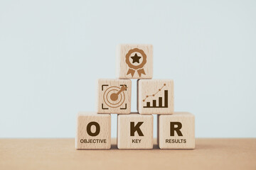 OKR, objective key results, text on wooden cube blocks. Business target and drive business and performance. Focus on goal. Project management. Achievement and growth