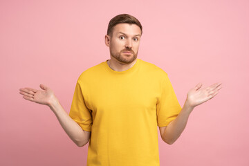 Confused man spreading hands shrugging shoulders what happened solves the dilemma, isolated...