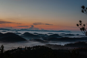 The scenery of Da Lat mountains and forests engulfed in morning mist