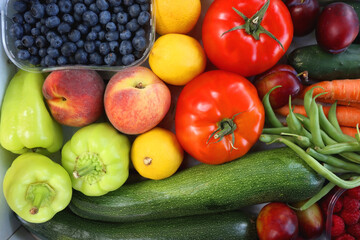 Wooden crate full of healthy colorful seasonal fruit and vegetable. Top view.