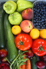 Wooden crate full of healthy colorful seasonal fruit and vegetable. Top view.
