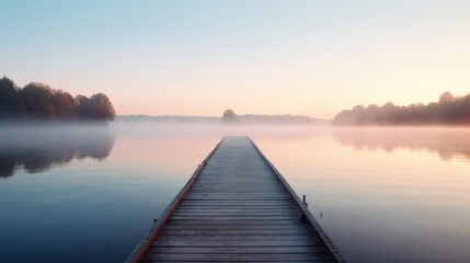 Woodenpier or jetty on lake at a foggy sunrise. Relax, vacations, or work life balance theme