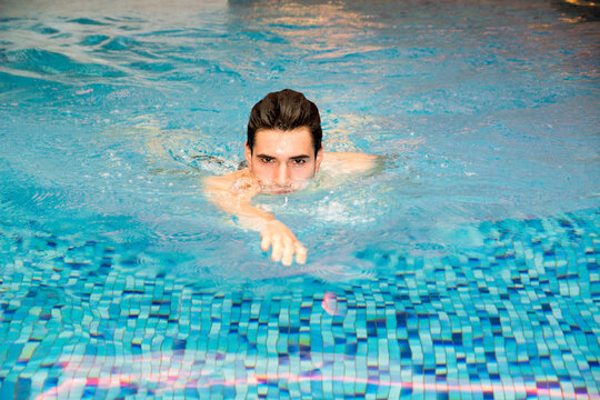 Photo of a man swimming in a pool of water