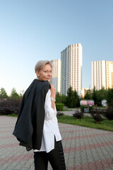 Obraz premium Portrait of an attractive middle age older woman walking forward in city. Happy confident 50s person