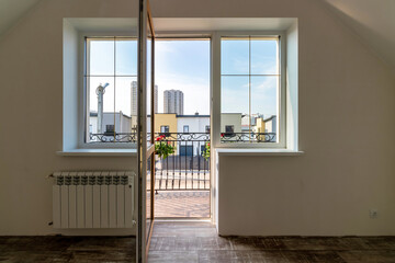 Open door to the balcony in a private house, view of a modern high-rise building