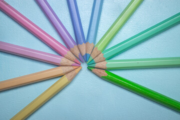 Fototapeta premium wooden pastel color pencils with isolated blue background and copy space