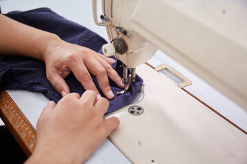 Portrait of Asian Tailor working with sewing machine