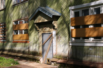 Boarded up outside windows and doors of an old residential building before demolition