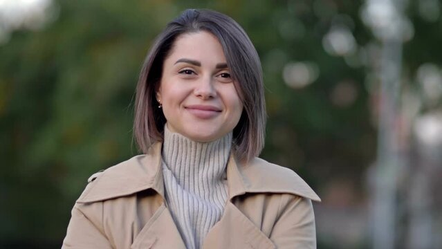 Portrait of young woman in spring park.