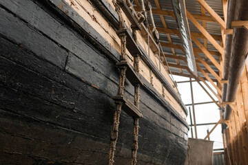 Fototapeta na wymiar board of an old wooden ship with a ladder in the museum