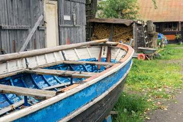 Fototapeta na wymiar old wooden boat on the shore in a seaside village