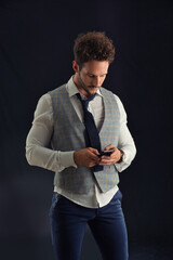 Photo of a man in formal attire looking at his smartphone