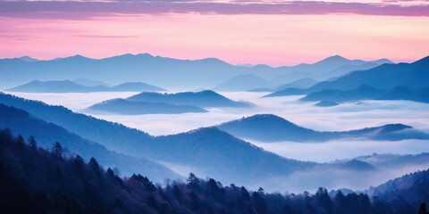 The mountains are shrouded in mist, and the last traces of daylight lend a tranquil, mystical quality to the scene. A twilight shot of autumn mountains under a fading pink and purple sky.