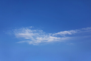 White fluffy cloud on blue bright sky background