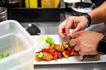 chef cooking chicken sweet and sour sauce on kitchen