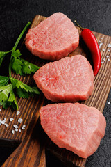 Raw Steak Fresh meat veal fillet on wooden board, dark background top view