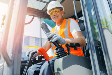 Close-up of builder hands operate crane or excavator at construction site