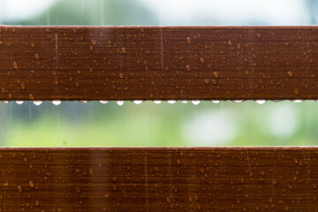 Drops of water on wooden bench after the rain, natural weather background - 641213060