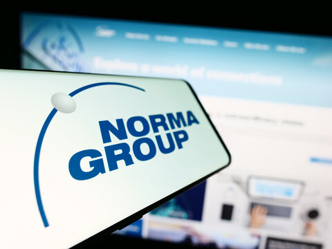 Stuttgart, Germany - 08-22-2023: Mobile phone with logo of German manufacturing company Norma Group SE on screen in front of business website. Focus on left of phone display.