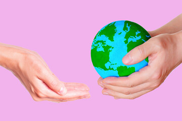 Globe Passing Between Hands on Pink
