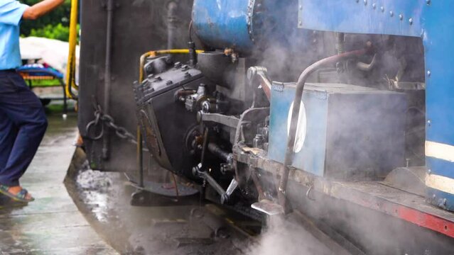 slow motion shot showing steam coming out of coal engine in the toy train a heritage tourist attraction in west bengal on a foggy day