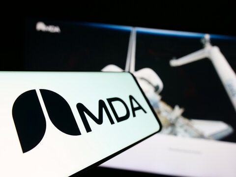 Stuttgart, Germany - 08-25-2023: Smartphone with logo of Canadian space technology company MDA Ltd. on screen in front of business website. Focus on left of phone display.