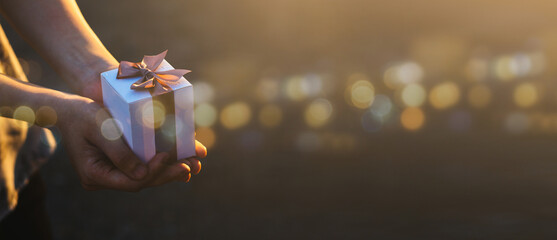 Females holding Christmas gift box decorated with Christmas and New Year banner Concept merry christmas and happy new year 2024