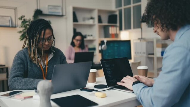 Multiethnic office team working as programmers, IT specialists, developers
