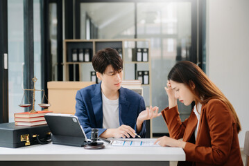 Business people compassionately holding hands and discussing contract papers with laptop and...