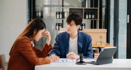 Business people compassionately holding hands and discussing contract papers with laptop and...