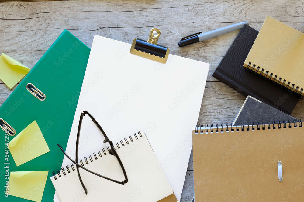 Poster black folder with a sheet of a4 paper and a green folder. blank page of a notebook for entering text