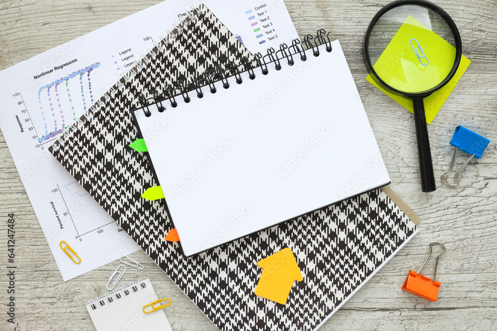 Poster open notebook on the table on financial charts. top view with copy space, flat lay.