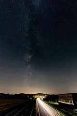 Zelfklevend Fotobehang Autoroute de nuit avec la voie lactée dans le haut de la photo © Olivier Rapin